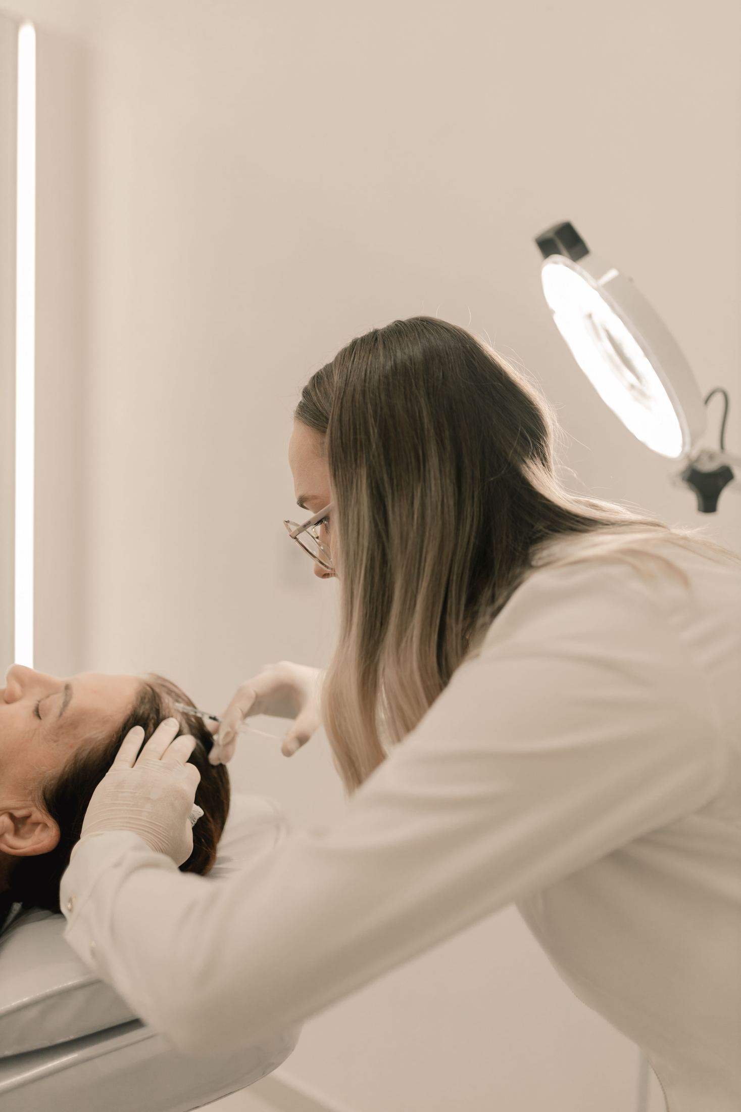 A provider performing an advanced scalp treatment