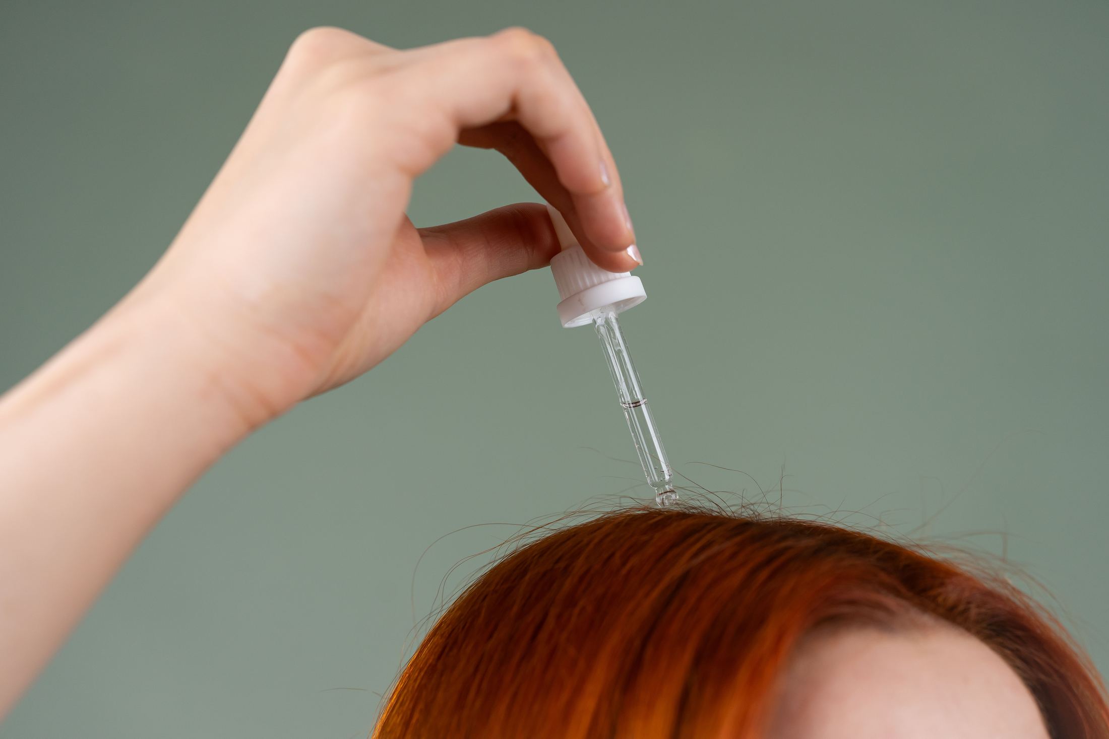 Applying a hair restoration treatment to the scalp