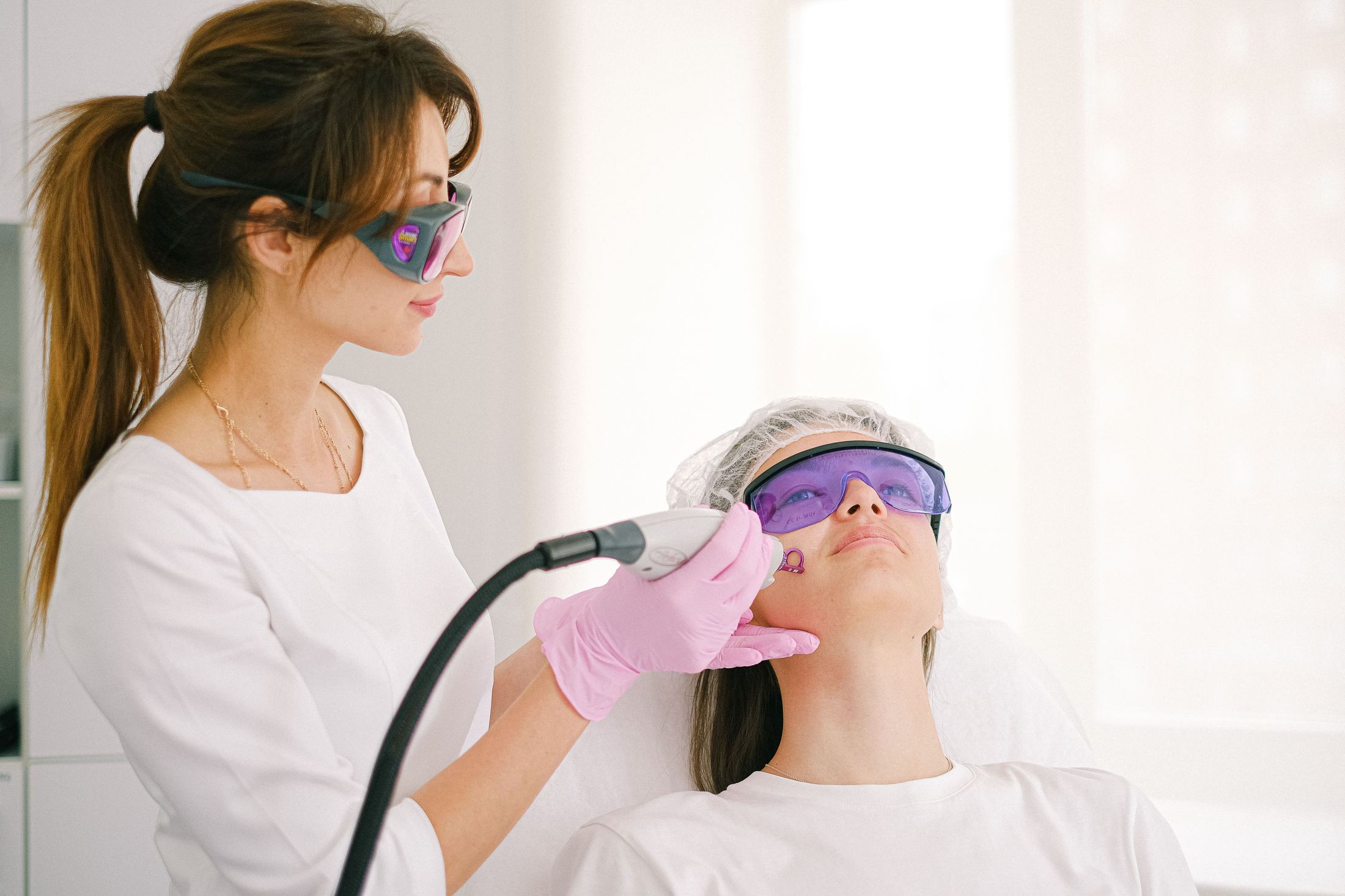A provider performing laser skin resurfacing on a patient