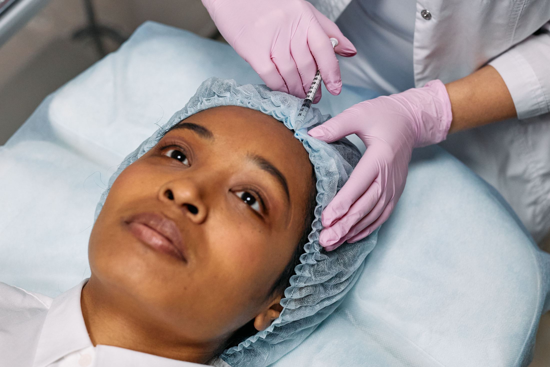 A toxin injection being administered to the forehead